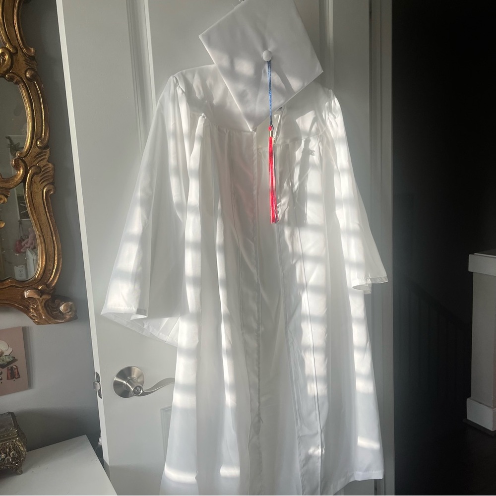 White graduation cap and gown